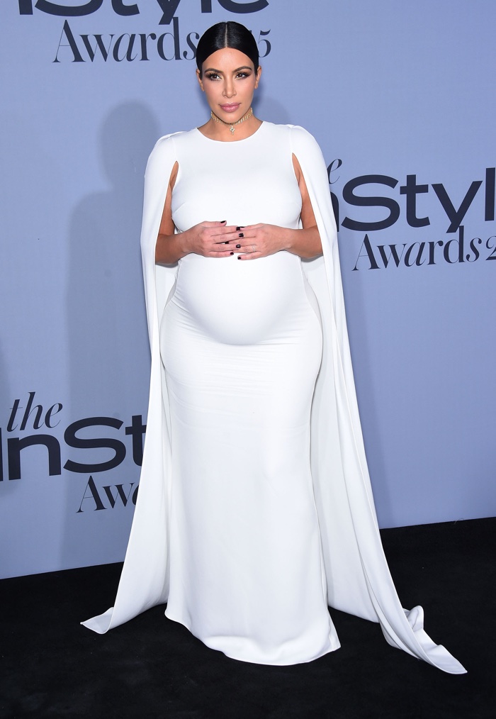 Kim Kardashian also showed off a pregnant stomach at the 2015 InStyle Magazine awards wearing a white cape and dress. Photo: Dfree / Shutterstock.com