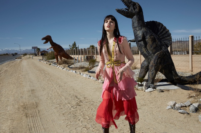 Captured next to dinosaur replicas, Lily Stewart models a Gucci dress with ruffles