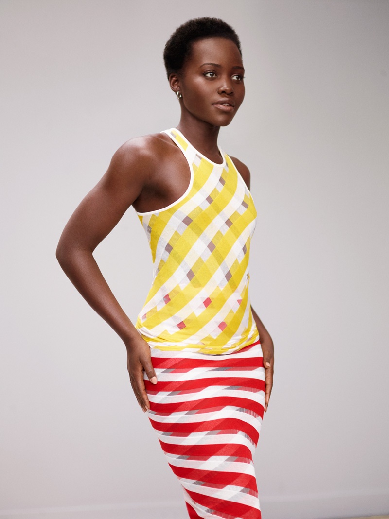 Lupita Nyong'o poses in a Stella McCartney dress in yellow and red