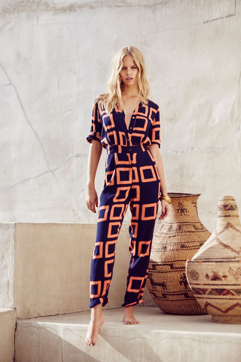 Photographed outdoors, Marloes Horst models a printed jumpsuit from Mister Zimi