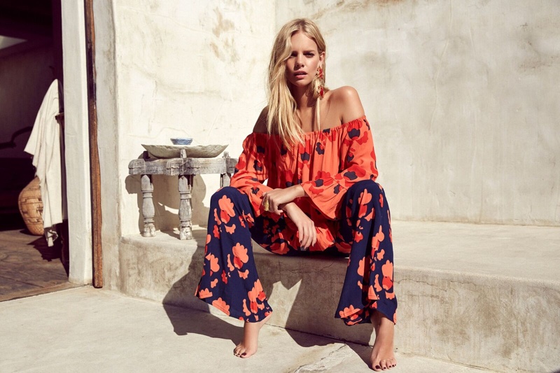 Marloes Horst takes a seat in Mister Zimi's off the shoulder blouse and flared printed trousers
