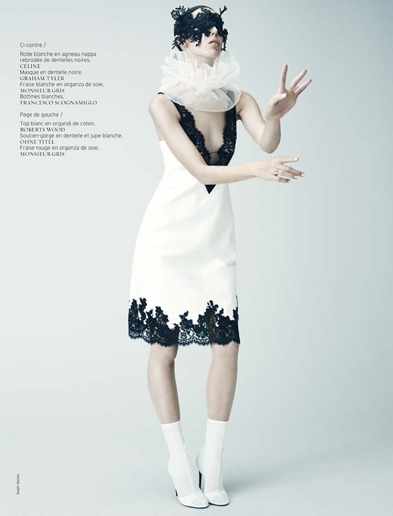 Wearing a mask, Ruby models a white Celine dress with black lace trim and white Francesco Scognamiglo boots