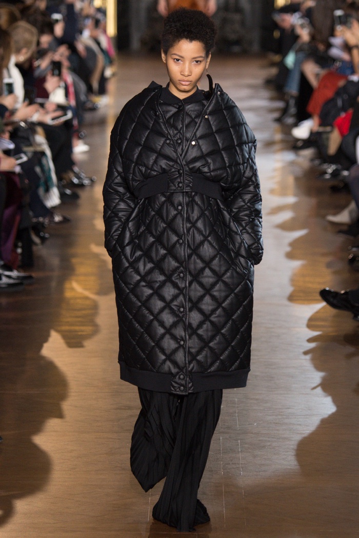 A model walks the runway at Stella McCartney's fall-winter 2016 show wearing a quilted coat and trousers