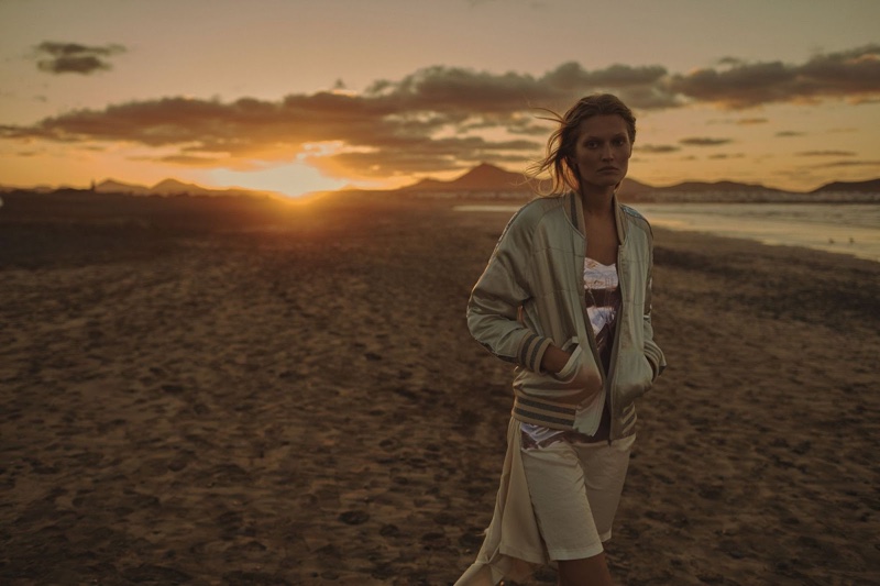 Walking the beach, Toni poses in a bomber jacket