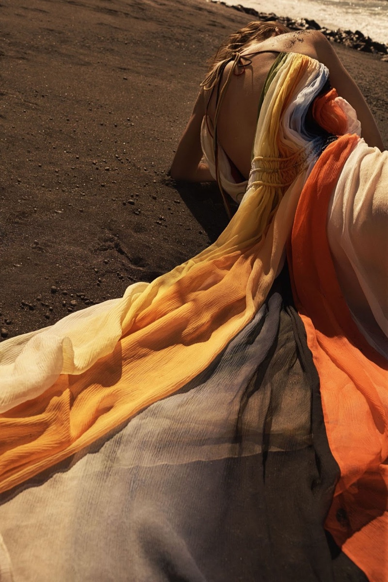 Lounging in the sand, Toni models a multi-colored Chloe maxi dress