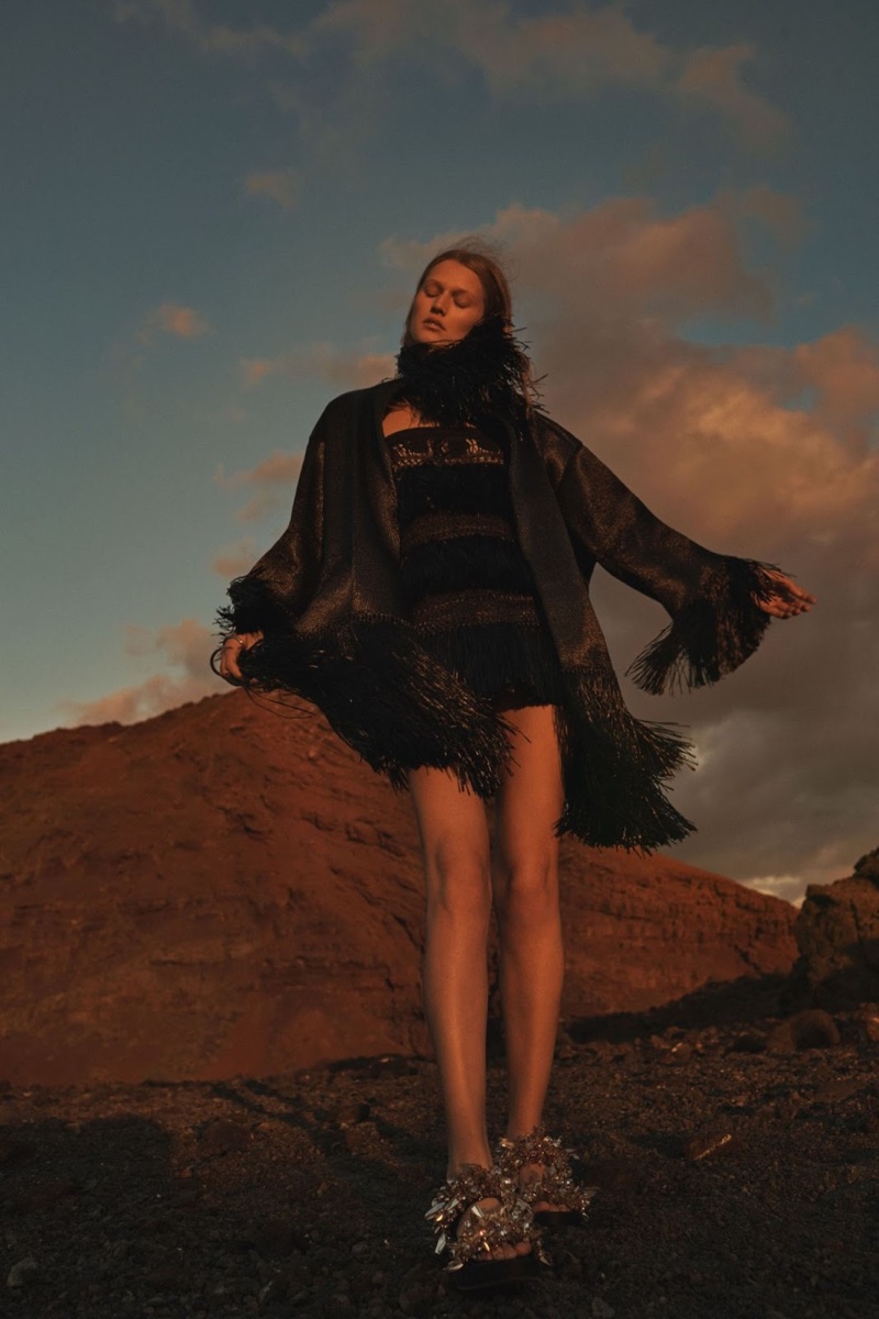 Posing with the wind, Toni wears a bell sleeve dress in black