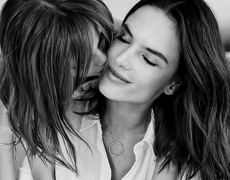 Alessandra Ambrosio wears a Michael Kors necklace while posing with her daughter, Anja