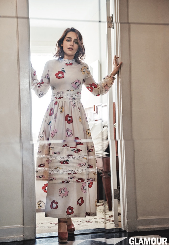 Emilia Clarke wears a long-sleeve Rochas floral print dress with platform heels