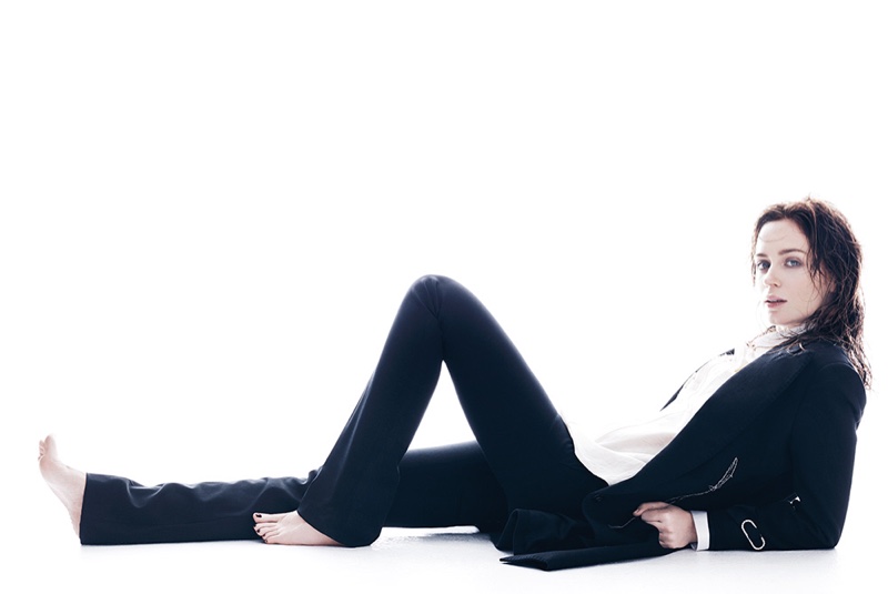 Posing on the ground, Emily Blunt suits up in a Lanvin coat and shirt with Bally pants