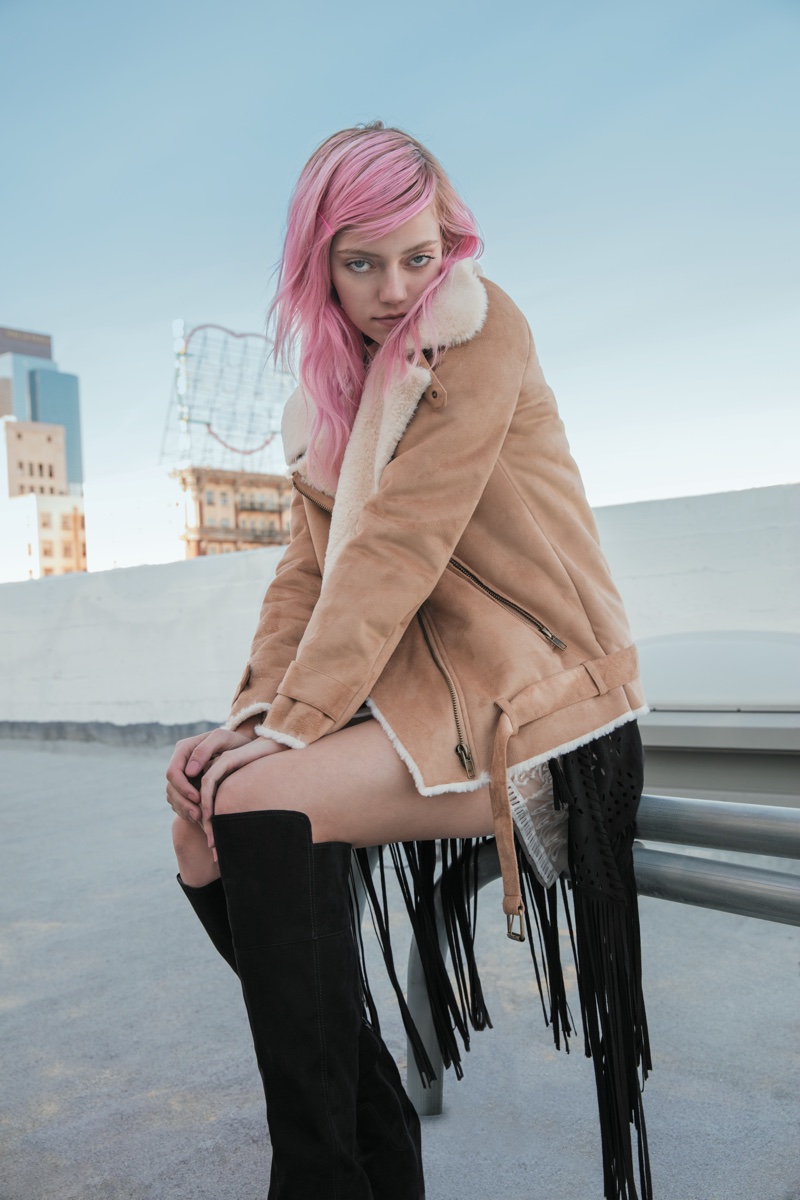 Pyper America Smith wears a faux shearling coat with knee-high boots from Forever 21