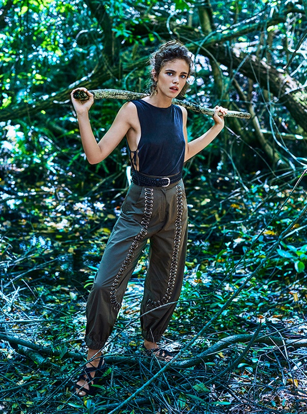 Posing in the woods, Jena wears a cut-out top with Fendi pants featuring metal embellishments