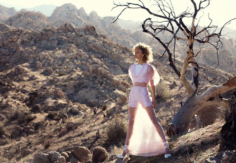 Sarah poses in the California desert wearing a sheer Dior dress over white lingerie top and shorts