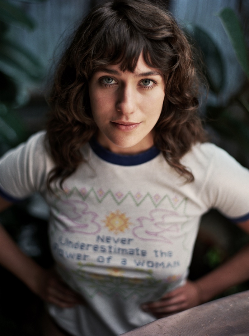 Wearing a shirt that reads: “never underestimate the power of a woman”, Lola Kirke poses for So It Goes Magazine