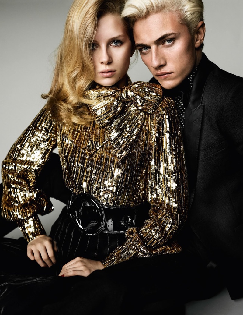 The pair glitter with Lottie modeling a sequin blouse, and Lucky wearing a tailored jacket from Saint Laurent