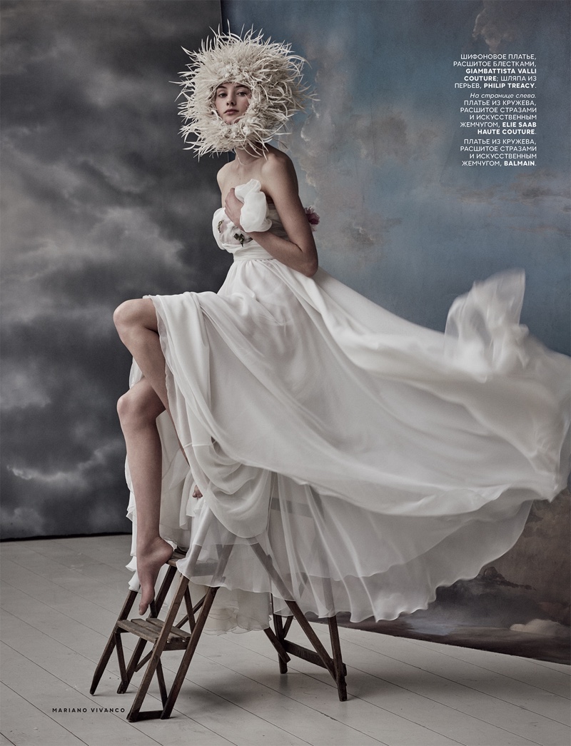 Looking ethereal, model wears Philip Treacy headpiece with white Giambattista Valli gown