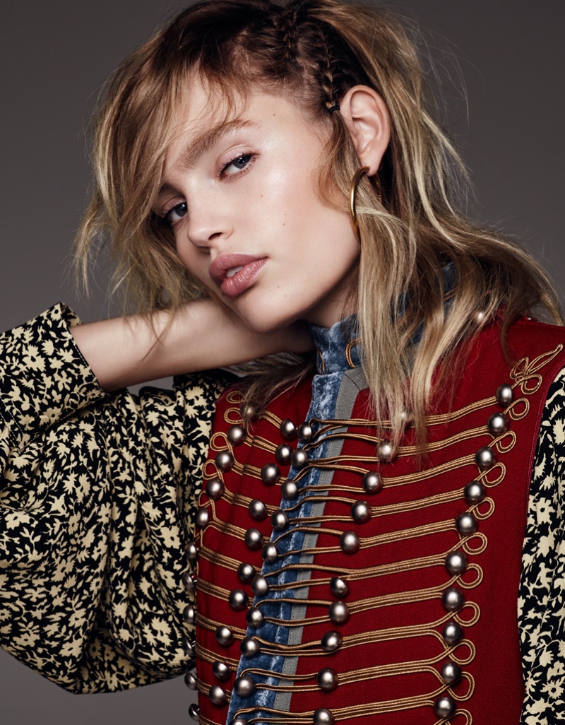 The model wears an embellished vest with floral print blouse