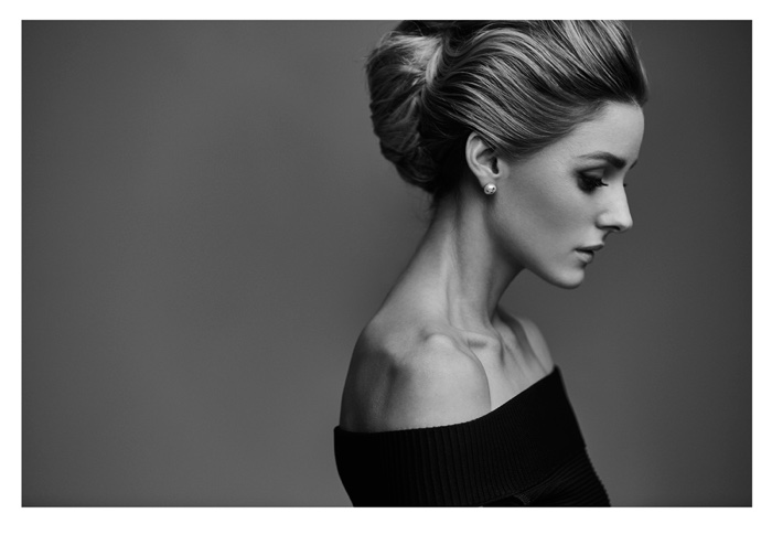 Photographed in black and white, Olivia Palermo wears a bouffant with blonde highlights