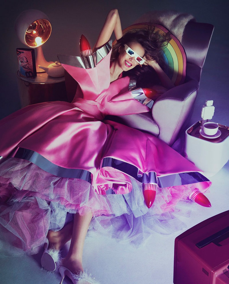 Model wears pink Moschino dress with tulle underskirt and retro car headlights