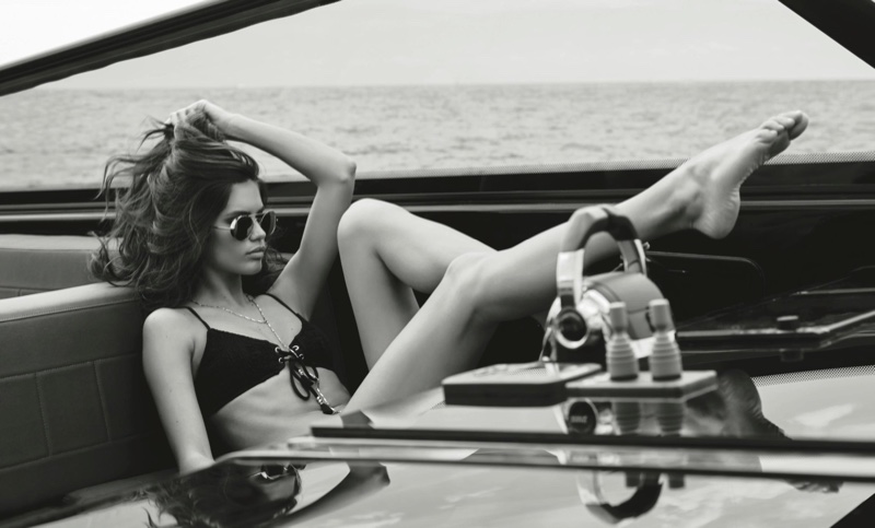Lounging on a yacht, Sara poses in a black bikini look