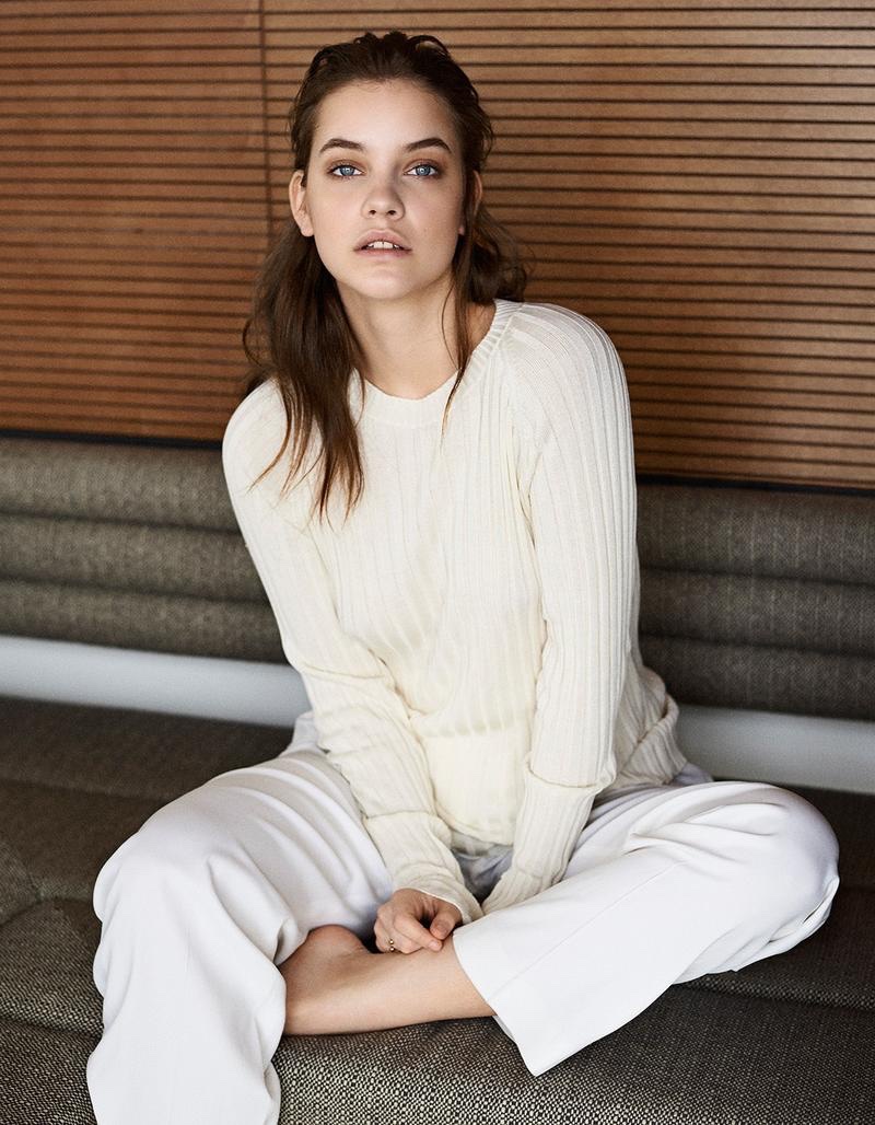 Barbara Palvin wears cream-colored pullover sweater with white trousers