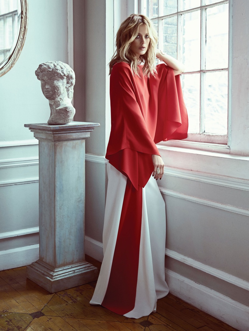 Posing next to a marble statue, Carolyn wears red blouse with red and white trousers from Ralph Lauren