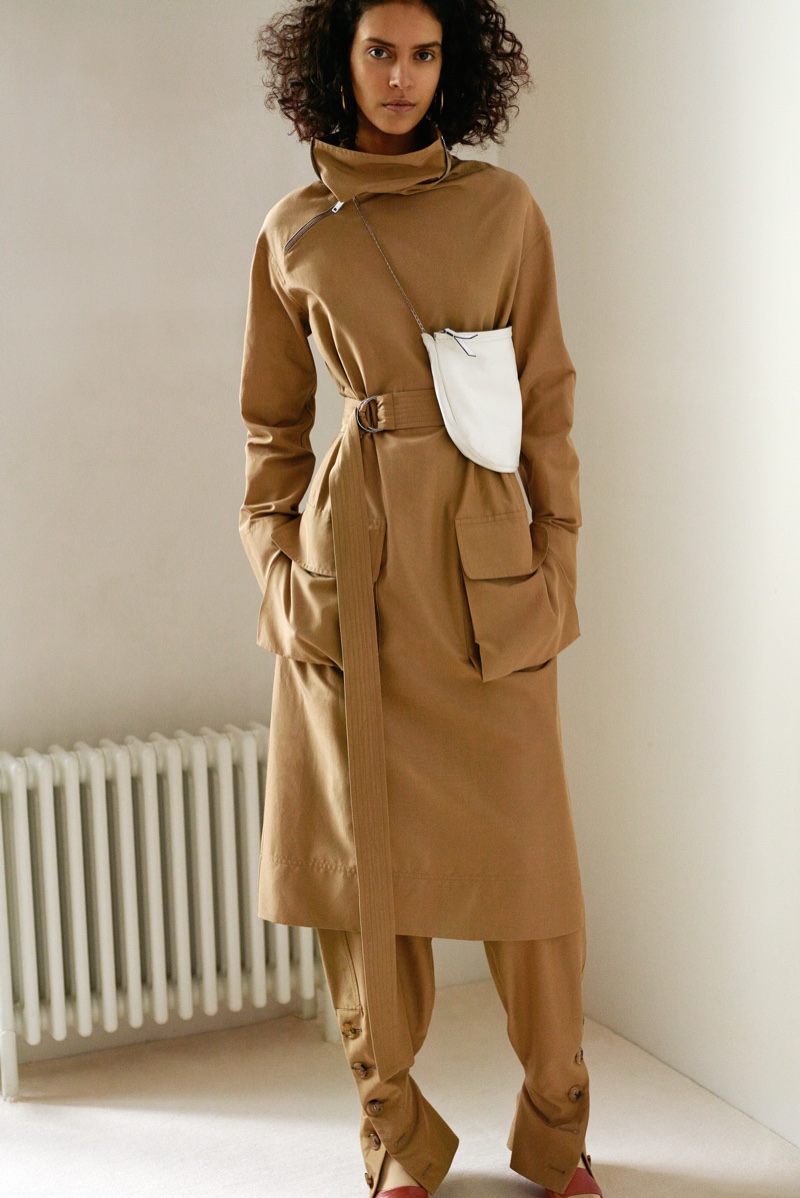 Model wears tan-colored coat and trousers from Celine's pre-fall 2016 collection
