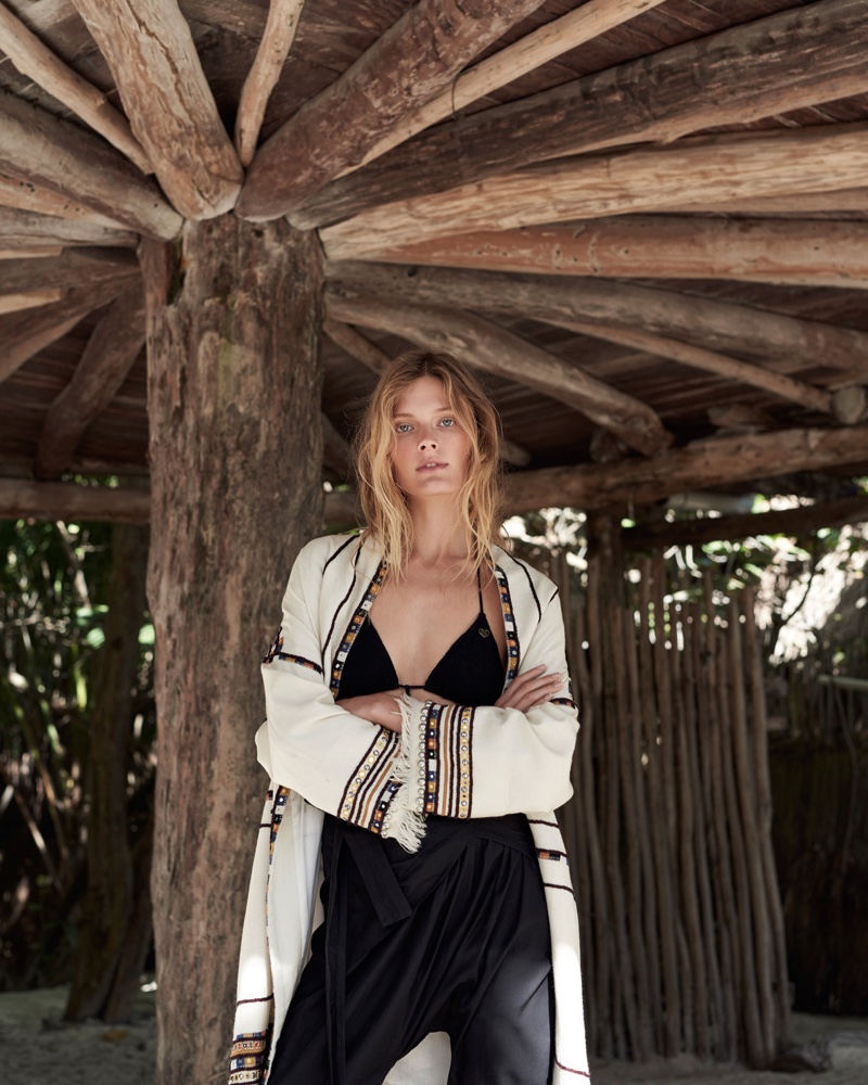 Posing with her arms crossed, Constance Jablonski wears Isabel Marant jacket, pants and leggings with a Banana Moon bikini top