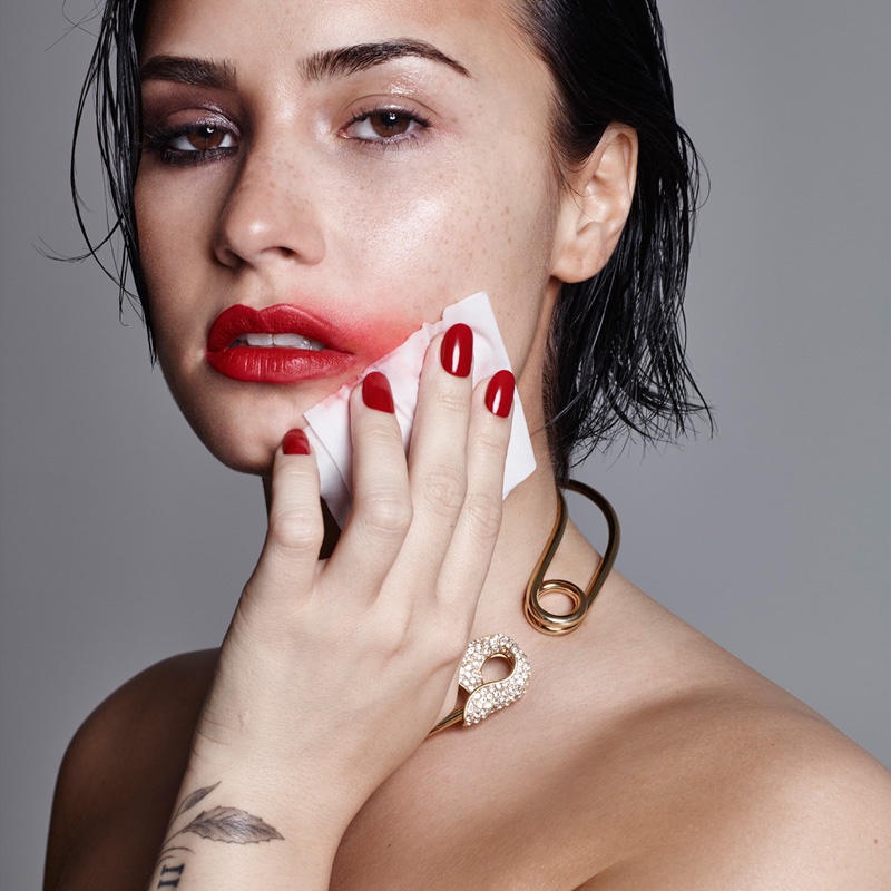 Demi Lovato wears a bold red lipstick with a matching manicure