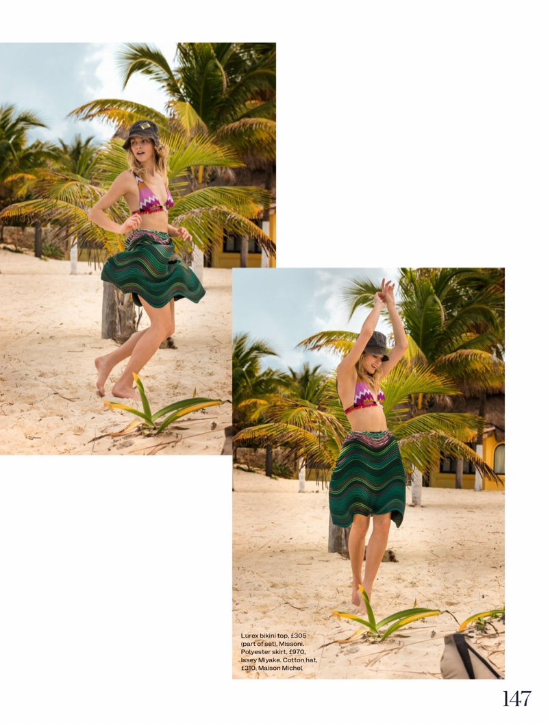 The model does a dance in Missoni bikini top with Issey Miyake skirt and Maison Michel hat
