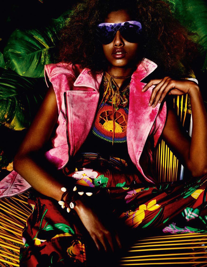 Posing with purple sunglasses, Imaan Hammam wears pink Roberto Cavalli vest, Tommy Hilfiger top and printed pants