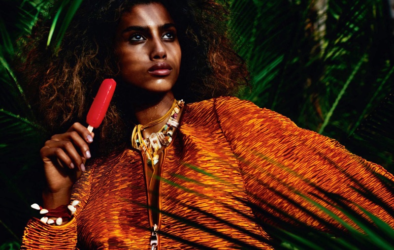 With a popsicle in hand, Imaan Hammam models zip-up top with embellished necklace and bracelet