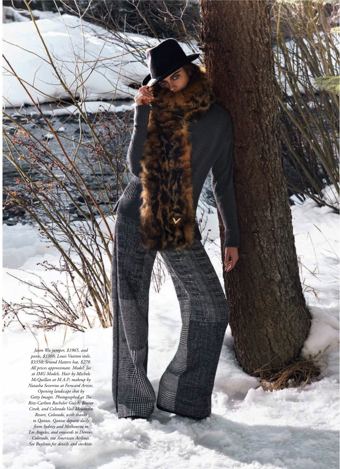 Jac Jagaciak looks ready for cold weather in a sweater, fur scarf and trousers