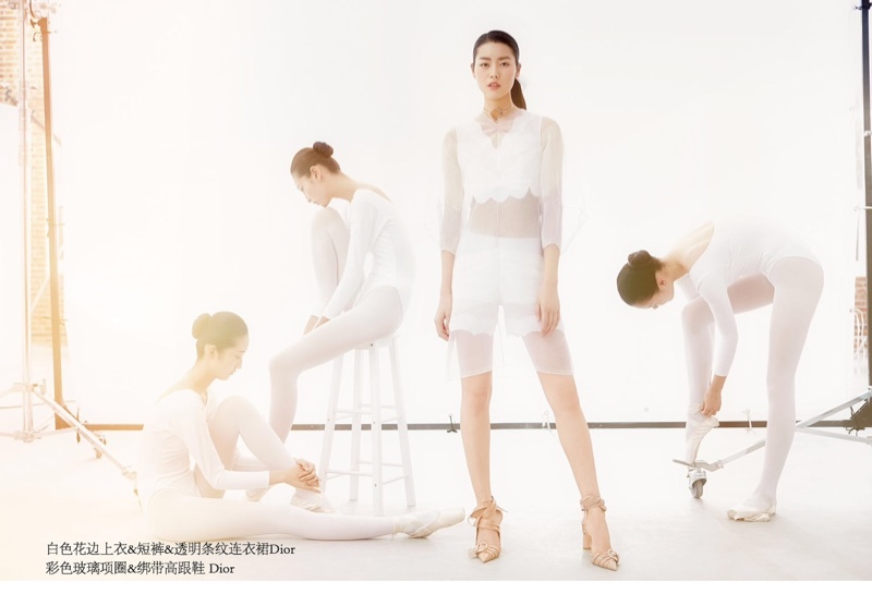 Posing alongside ballet dancers, Liu Wen models Dior sheer dress, crop top and shorts in white