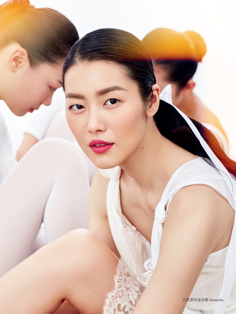 Liu Wen wears a dreamy makeup look with a red lip color and rouged cheeks