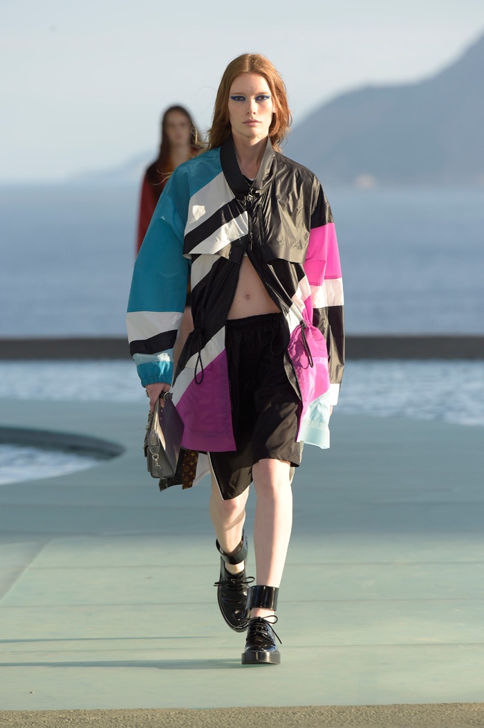 A model walks the runway at Louis Vuitton’s resort 2017 show wearing an oversized jacket and shorts