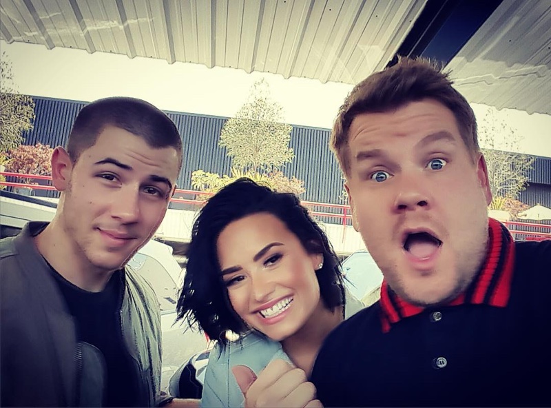 Nick Jonas, Demi Lovato and James Corden pose for a selfie