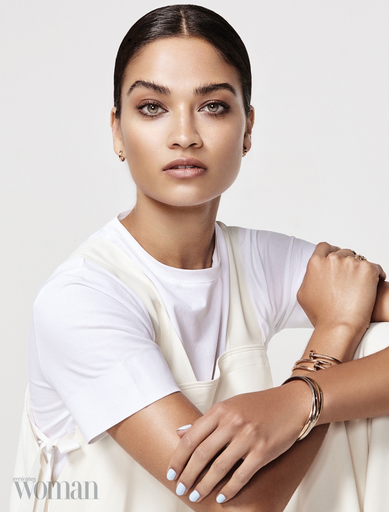 Shanina Shaik poses in Cartier earrings and bracelets with DKNY t-shirt and Helmut Lang dress