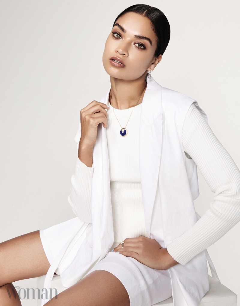 Shanina Shaik takes a seat in DKNY sleeveless jacket, wrap skirt and short with T by Alexander Wang ribbed sweater