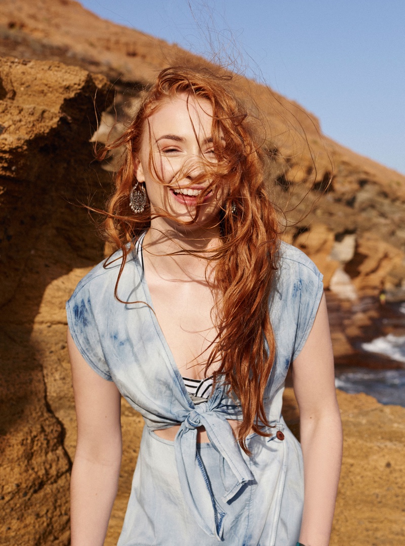 Sophie Turner wears ASOS tie-dye denim wrap dress, jersey top and hoop earrings