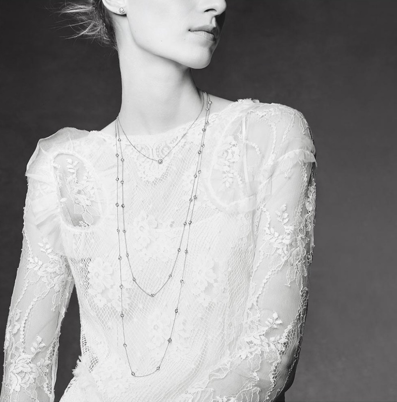 The model poses in all white looks while wearing Tiffany & Co. jewelry