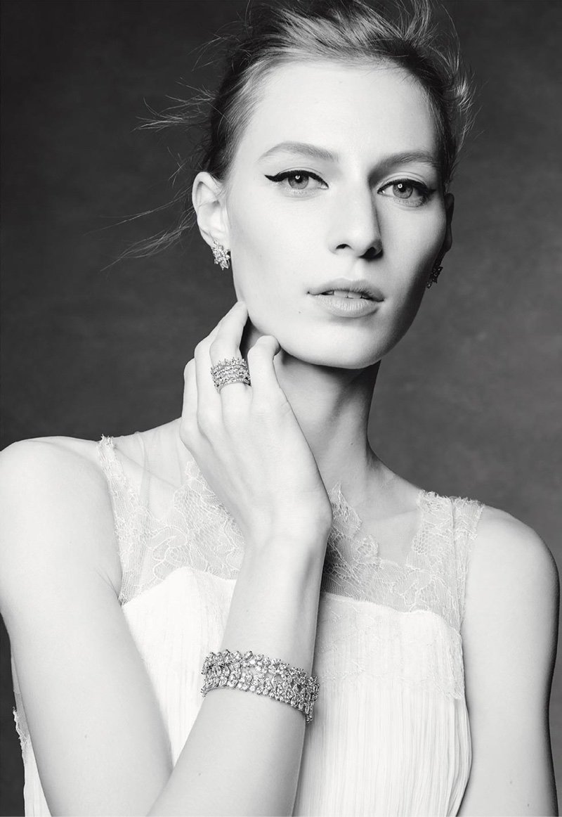 Wearing winged eyeliner, Julia Nobis models earrings, rings and bracelets from Tiffany & Co.