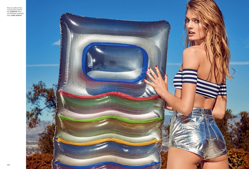 Posing with a pool toy, Constance Jablonski wears off-the-shoulder striped crop top and metallic shorts