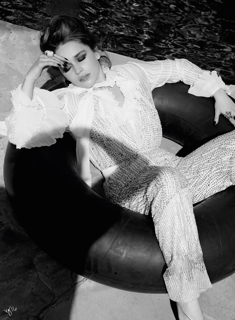 Photographed in black and white, Emilia Clarke wears Rodarte blouse and pants