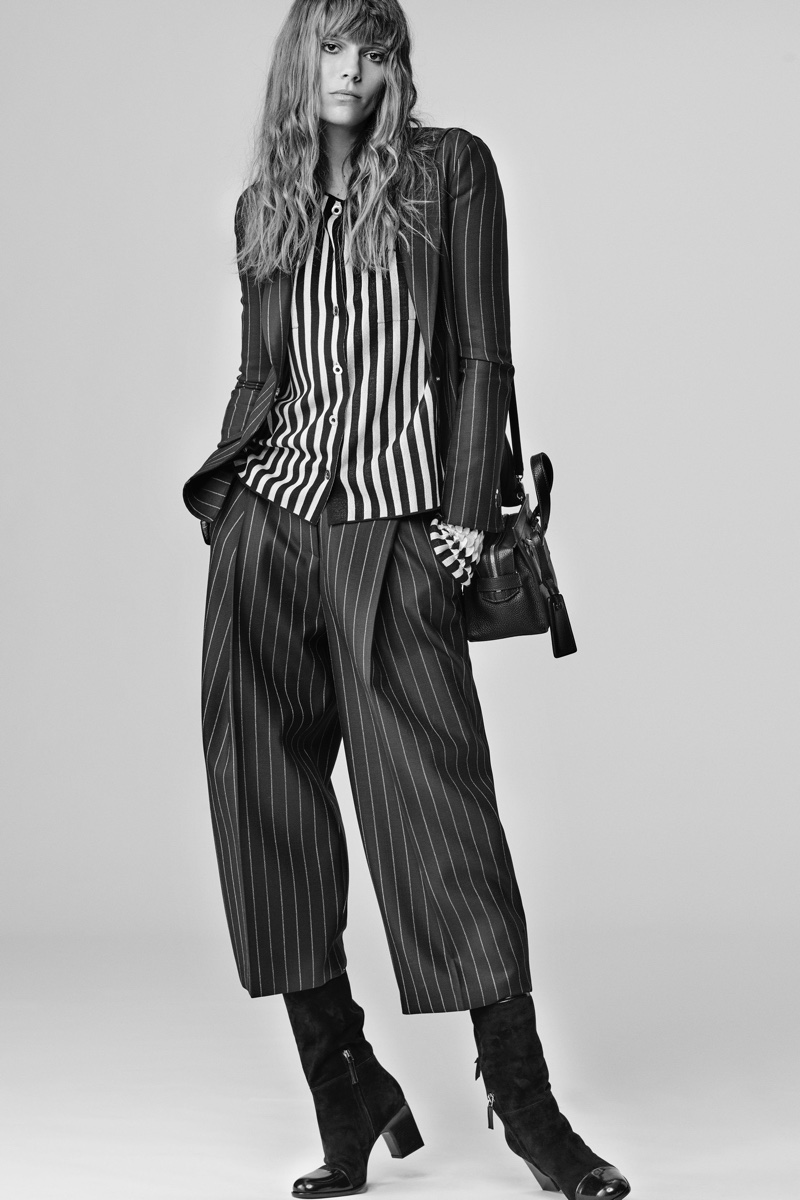 Model wears striped silk blouse, jacket and pants in pinstripe wool from Giorgio Armani's fall-winter 2016 collection