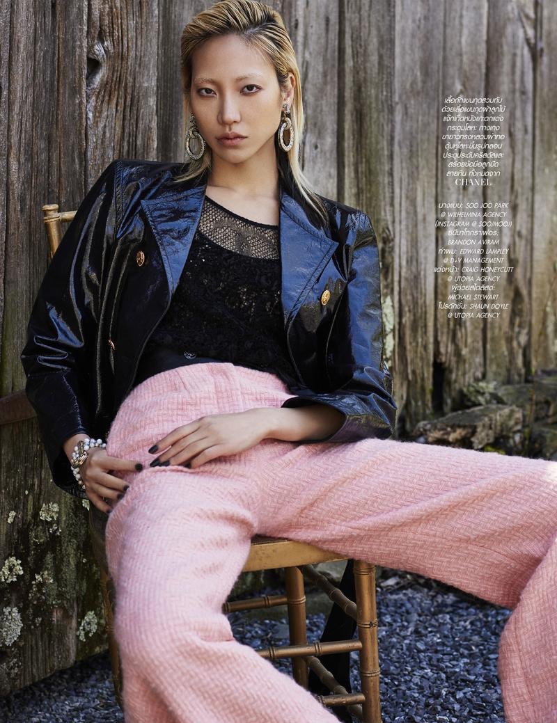 Soo Joo Park wears leather jacket, black top and pink trousers from Chanel