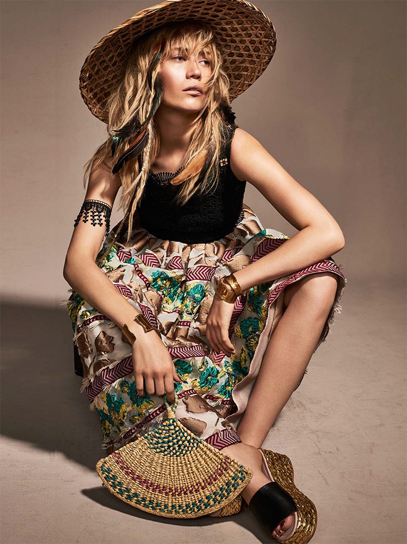 The blonde model wears embroidered top and jacquard skirt from Antonio Marras