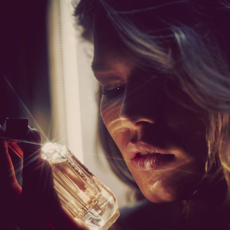 Anna Ewers gazes at BOSS' perfume bottle in behind the scenes shot
