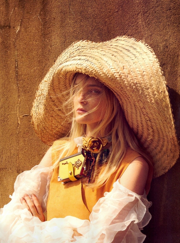 Carolina Trentini peeks out from an oversized straw hat for the fashion editorial