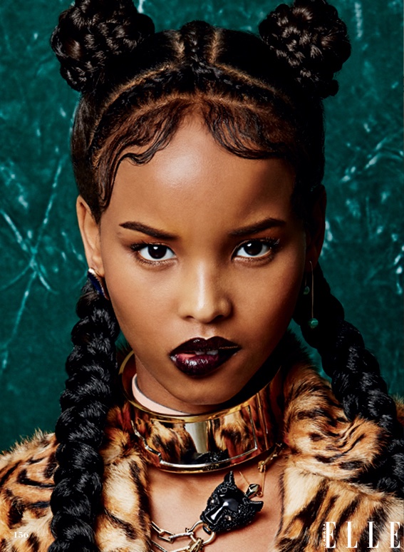 Model wears braided hairstyle with gelled baby hairs