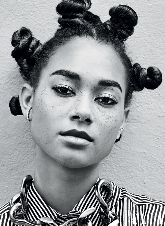 Model poses with bantu knots